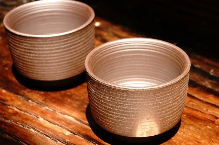 Textured Arabic-style tea cup, stacked in warm copper-brown ceramic with fluted walls