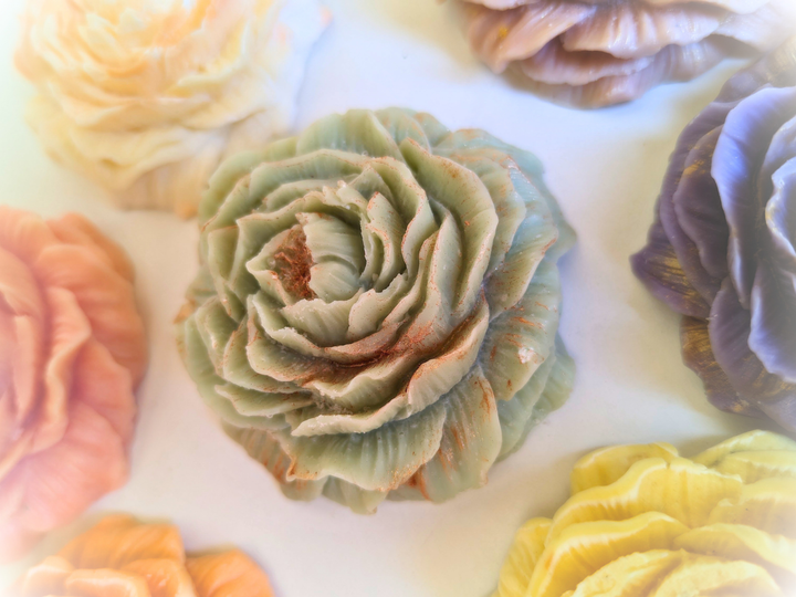 Close-up of green wax flower freshener with textured rose petals