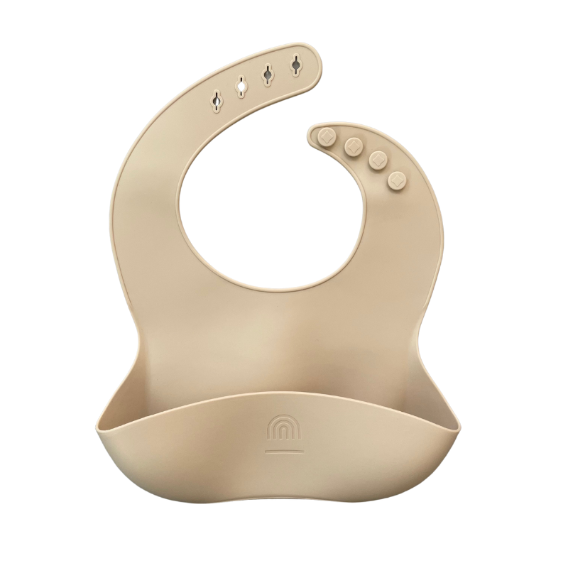 Tan silicone bucket bib with button closure and wide food catcher pocket