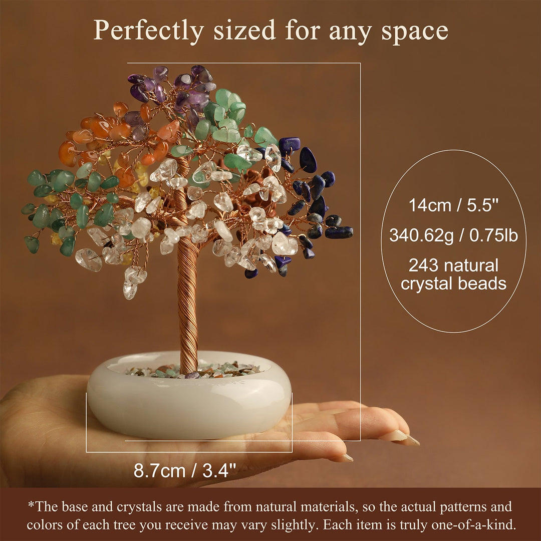 Multicolor crystal gemstone tree in a white resin base held in hand