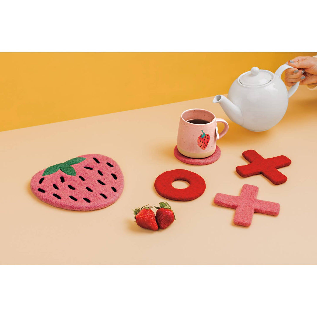Peach ceramic mug with strawberry print, side view with curved handle