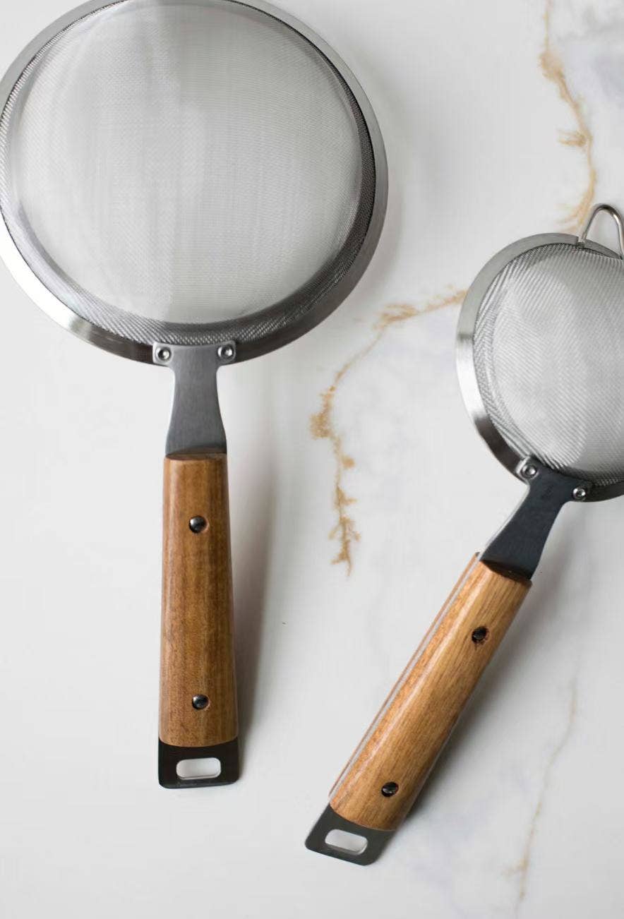 Round mesh strainer with silver rim and fine mesh screen, wood handle with hanging loop