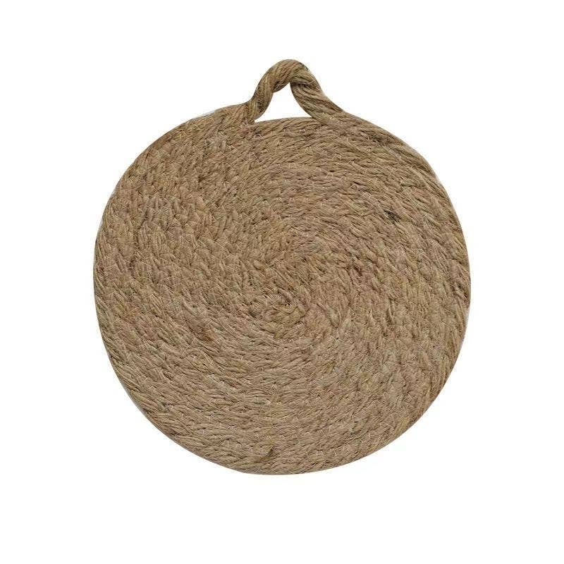 Round woven natural trivet with top handle loop, full front view