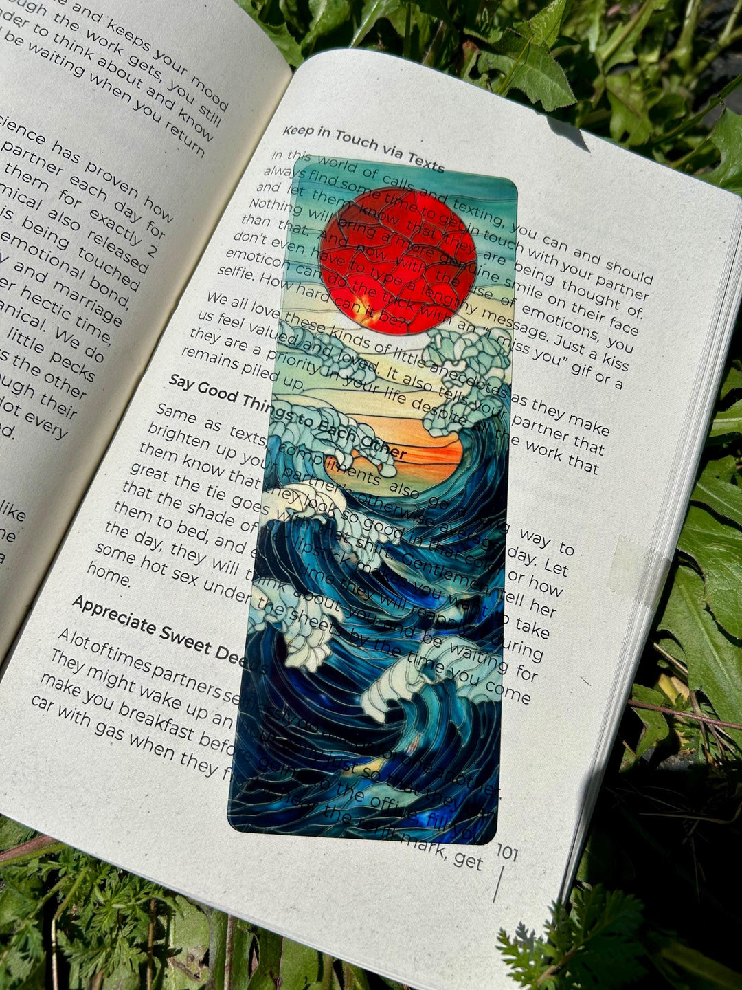 Ocean waves bookmark detail: blue wave pattern with red circle and script-style text