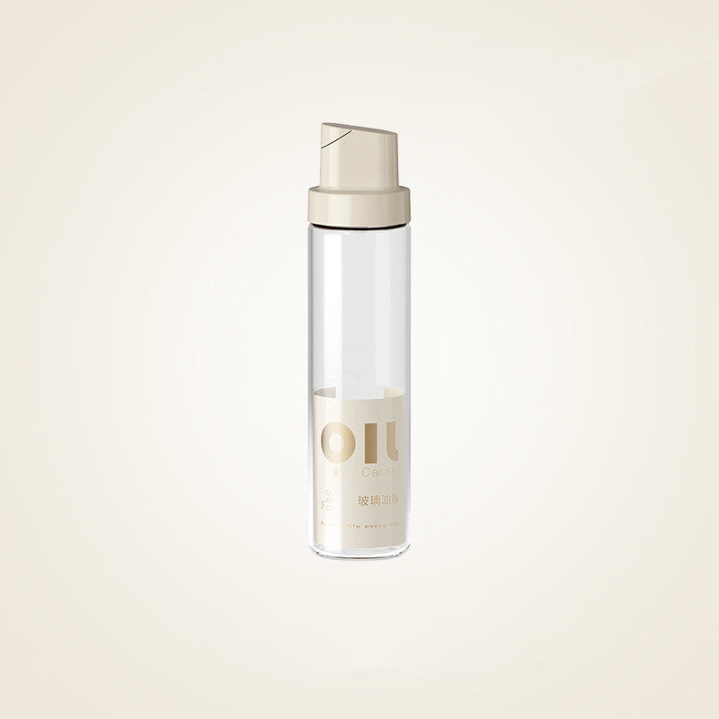 Clear glass oil dispenser bottle with warm grey cap