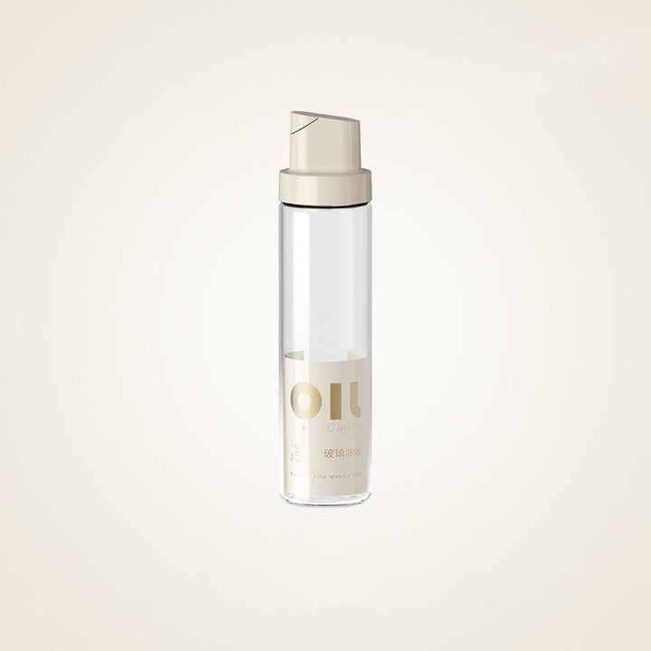 Clear glass oil dispenser bottle with warm grey cap