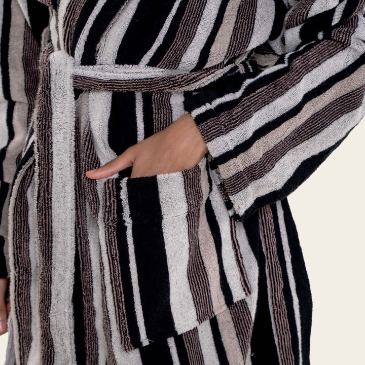 Striped unisex cotton bathrobe with hood, belt tie, and front pockets, close-up detail