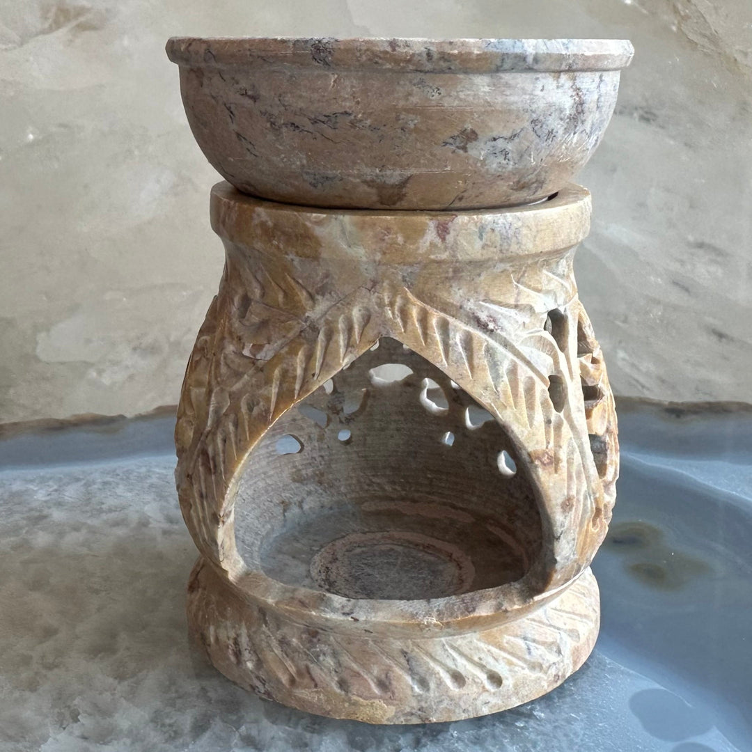 Carved soapstone essential oil burner with curved cutout and leaf-carved sides