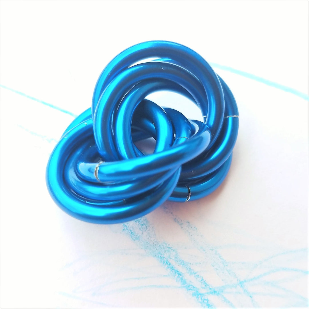 Metallic blue twisted stress ball fidget toy, coiled rings shape