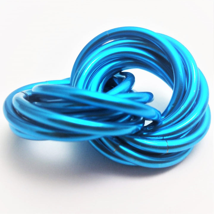 Bright blue metallic twist fidget stress ball, knotted loop desk toy.