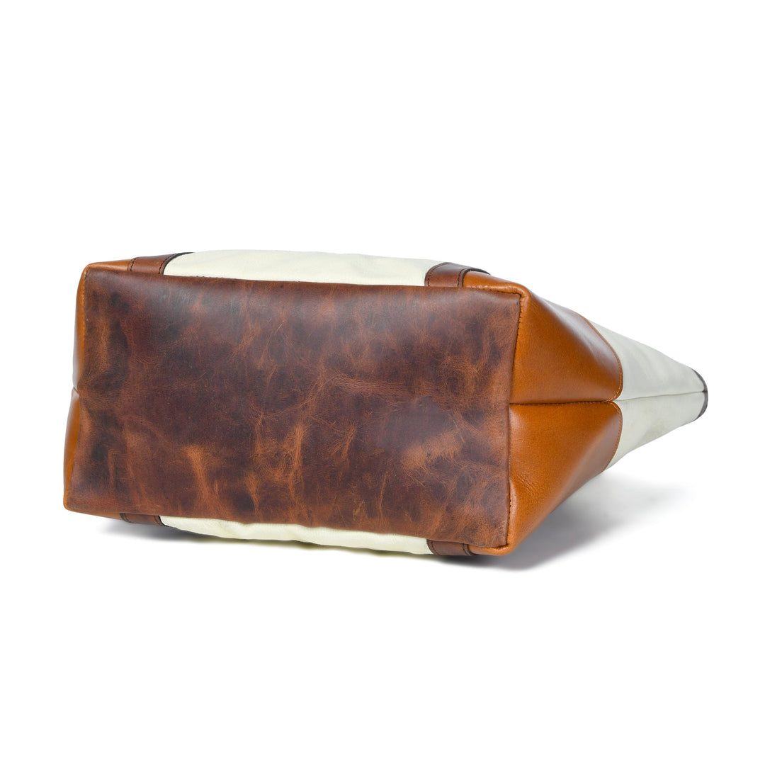 Brown and cream leather tote with geometric paneling and top handles