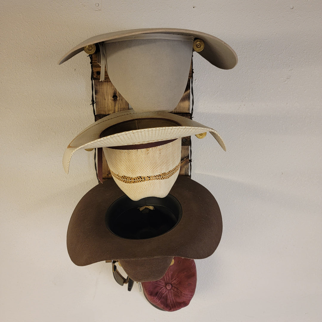 Wall hat organizer displaying cream and dark brown hats on vertical wood frame