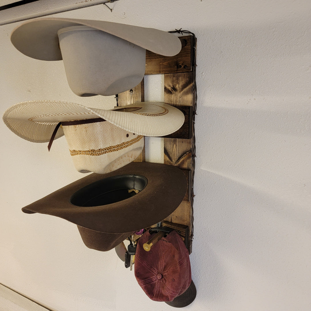 Vertical hat holder rack with cream, dark brown, and burgundy caps hanging