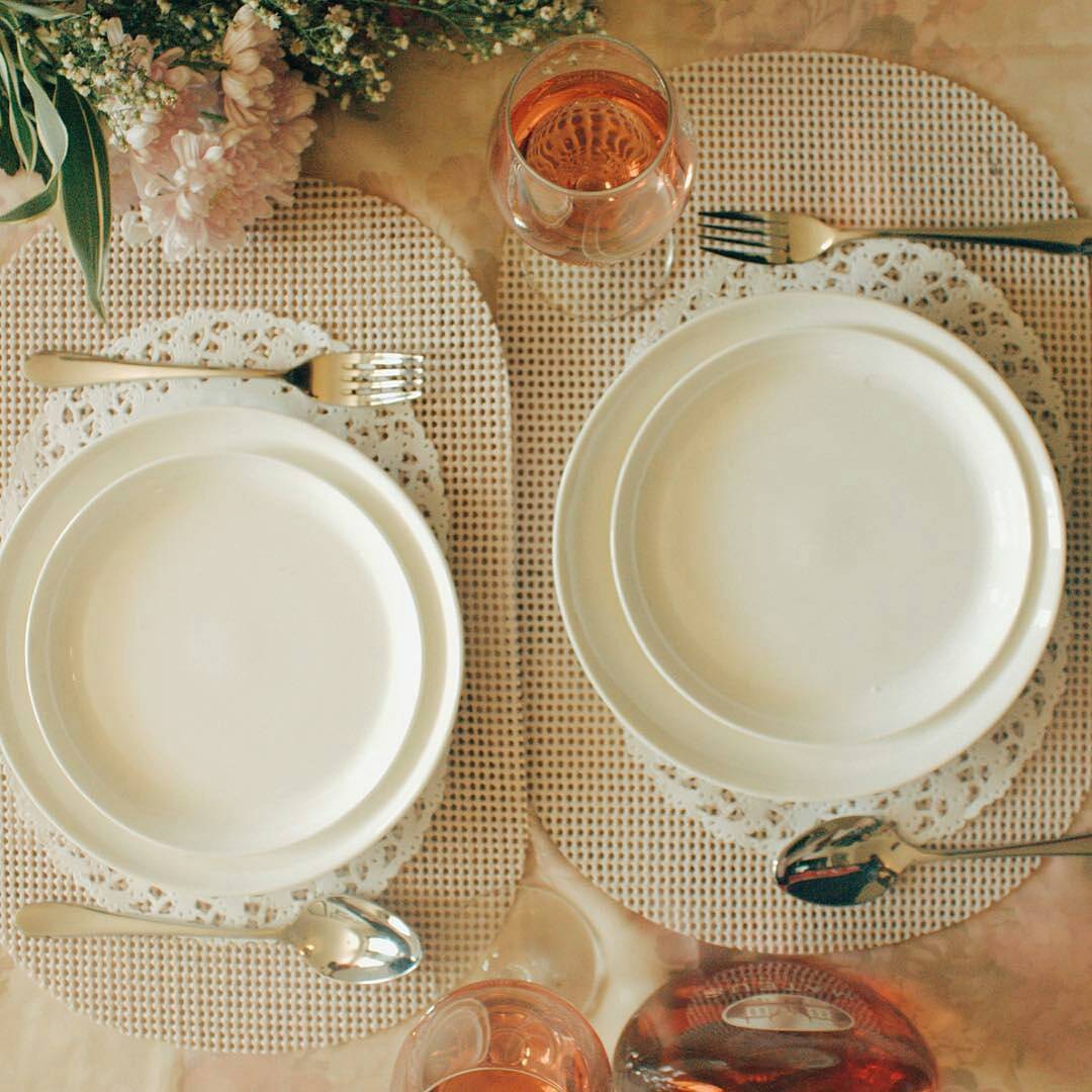 Set of two white round dinner plates with smooth rims.