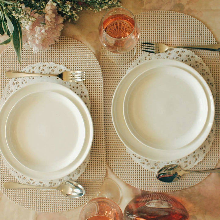 Set of two white round dinner plates with smooth rims.