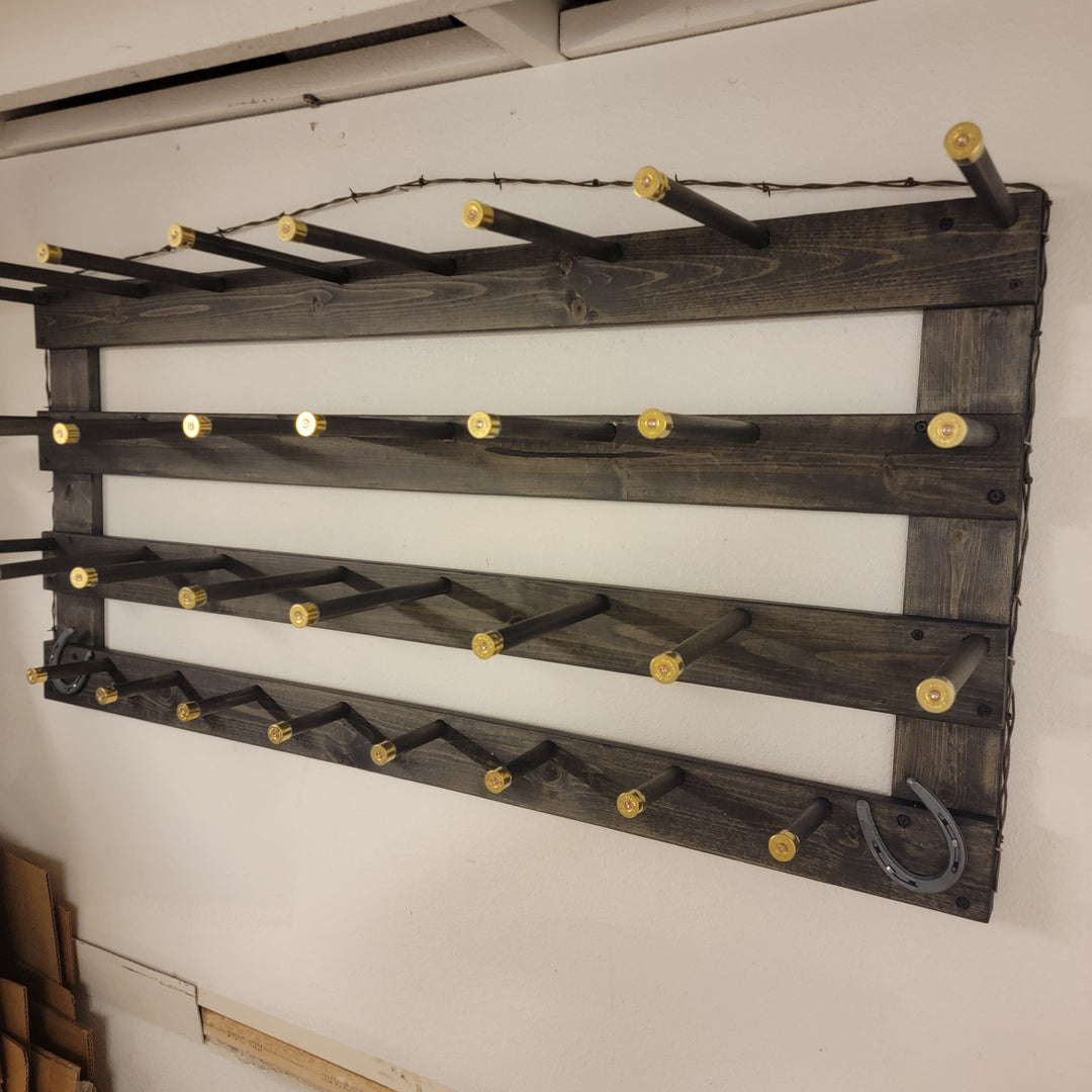 Wall-hanging western organization board with dark slats and brass peg hooks, angled view