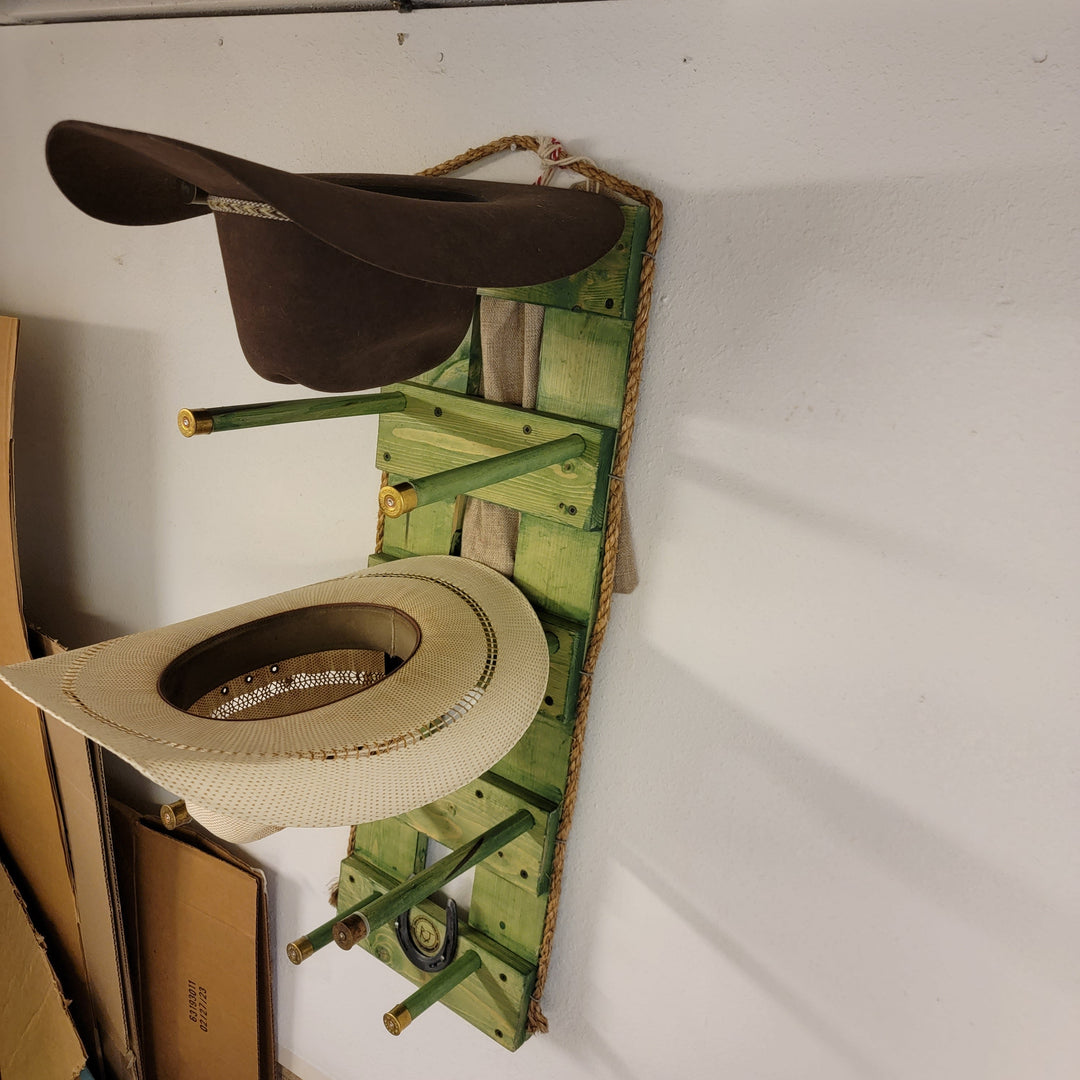 Green wooden wall hanging organizer with mounted hats and brim holder shelves
