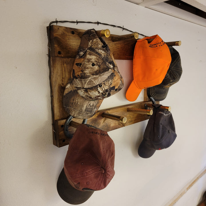 Vertical wall-hanging ball cap organizer with camo, orange, and brown caps on hooks