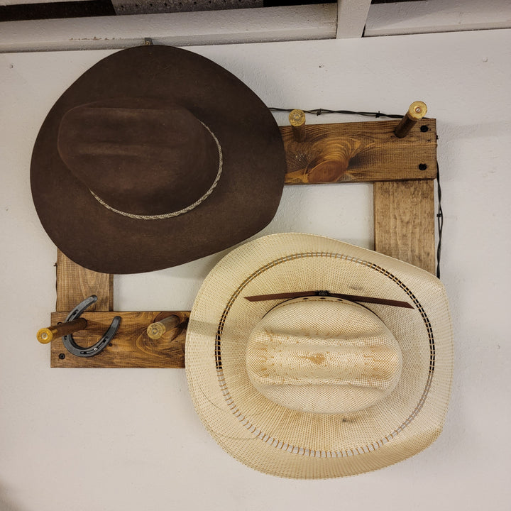 Vertical wall-hanging ball cap organizer featuring dark brown and light straw wide-brim hats