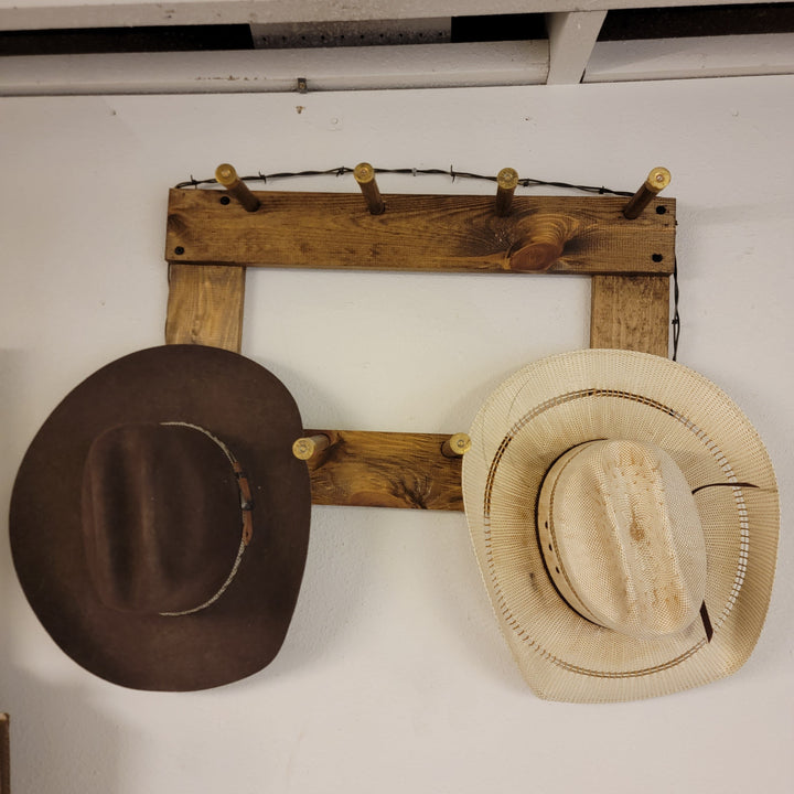 Vertical wall-hanging ball cap organizer with dark brown and beige straw hats