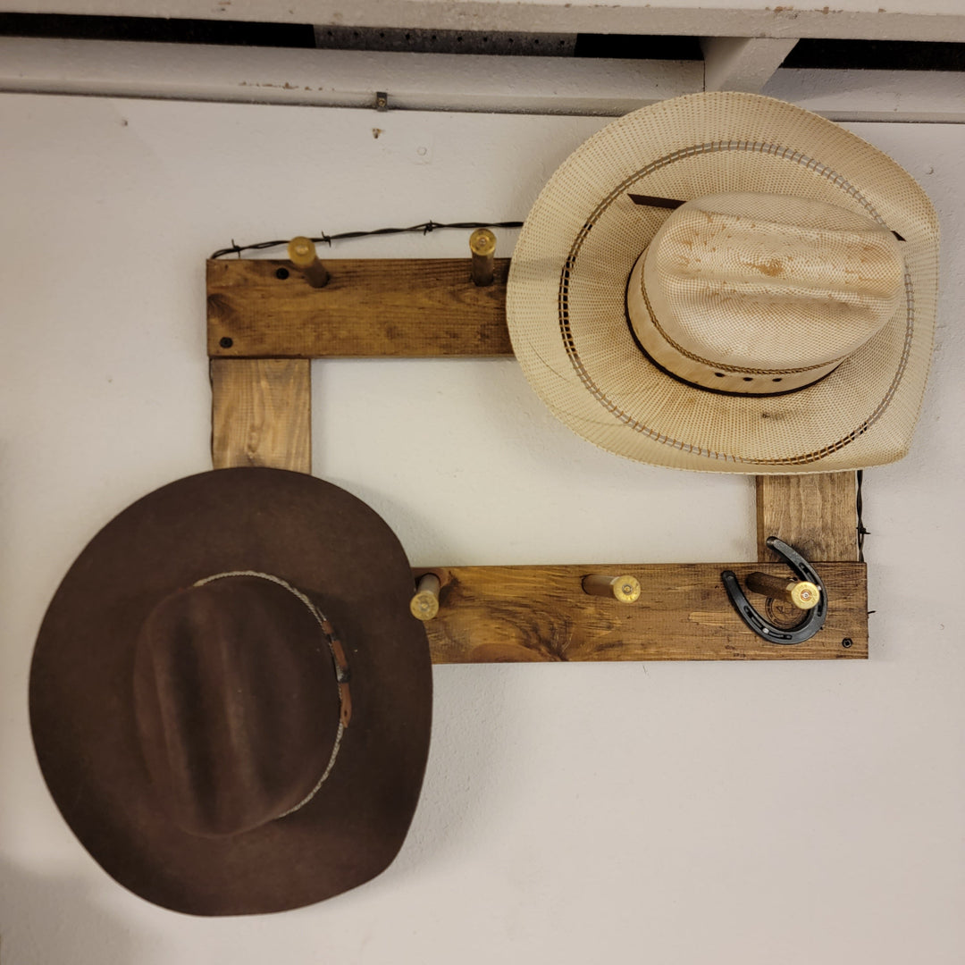 Vertical wall-hanging ball cap organizer with beige straw hat and dark brown hat on hooks