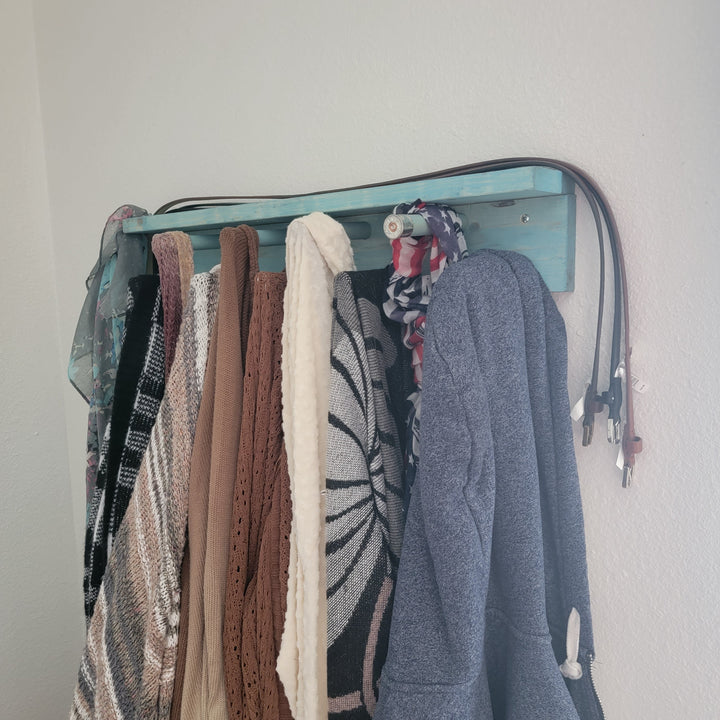 Blue scarf rack with shelf, showing hanging scarves on rotating pegs