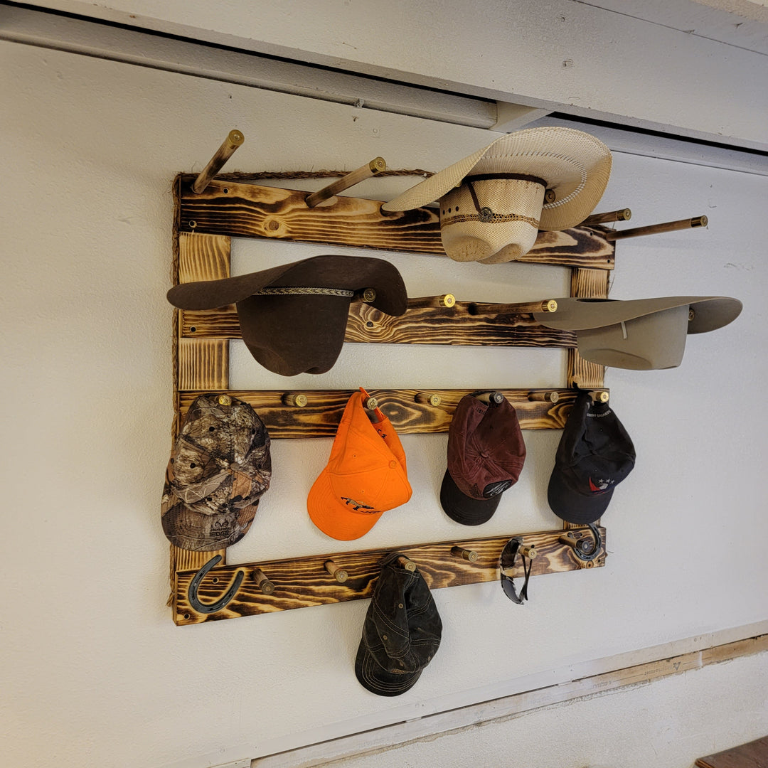 Wood wall hat rack with cowboy hats and multiple baseball caps, full front view