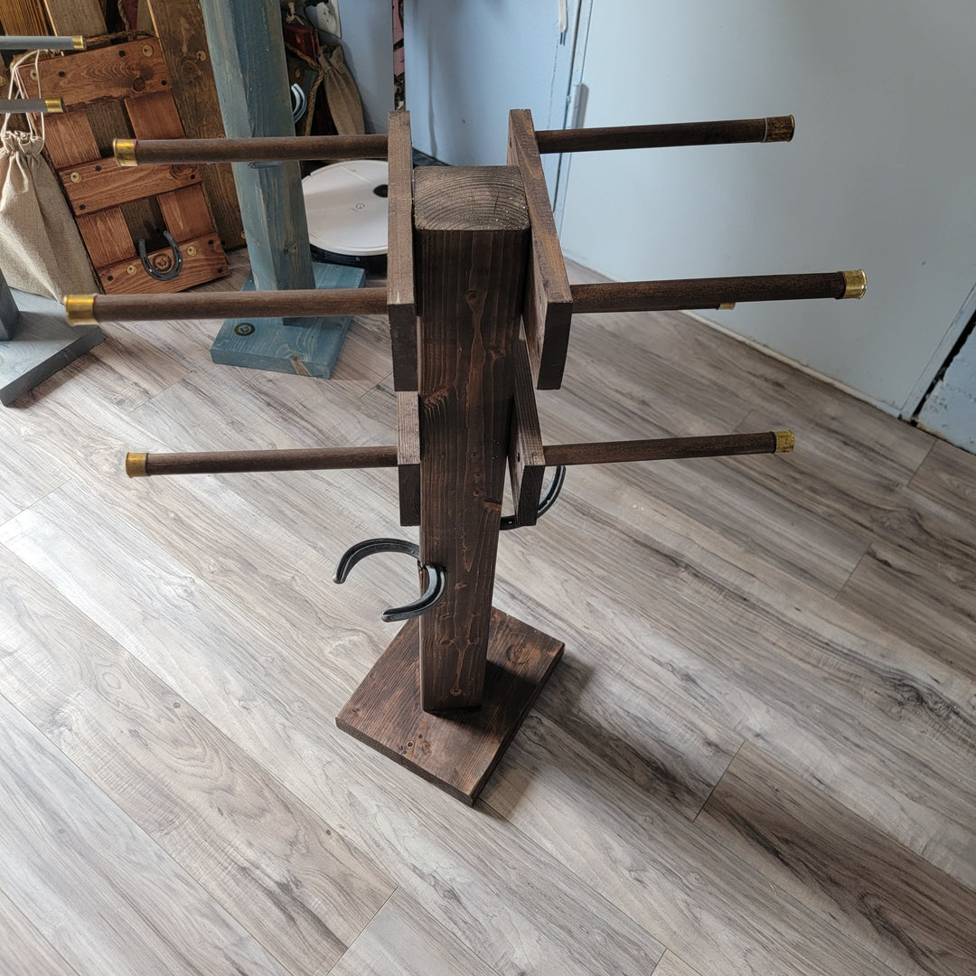 Wooden boot tree stand with curved arms and brass tips, on a square base