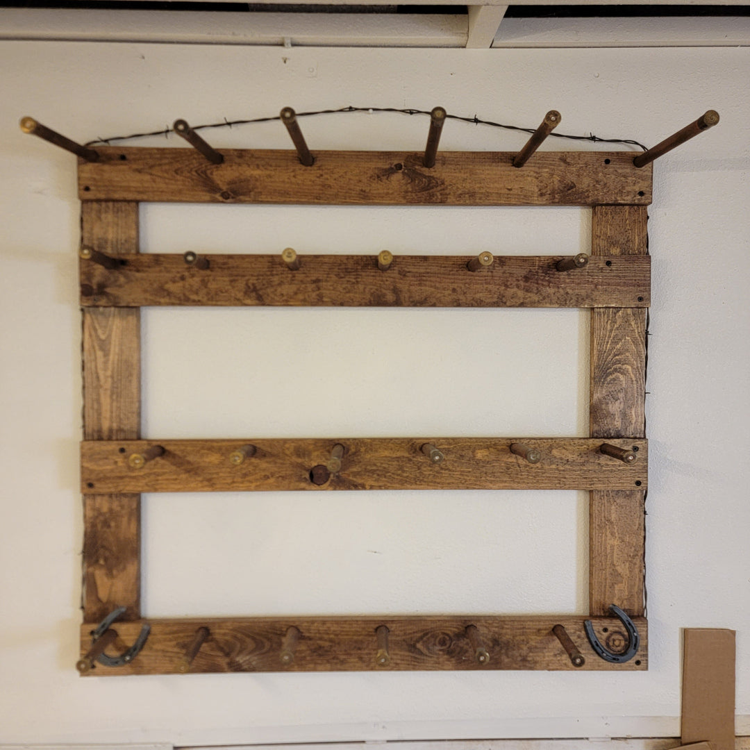 Wooden hat rack with multiple rows of metal hooks for hanging hats or caps