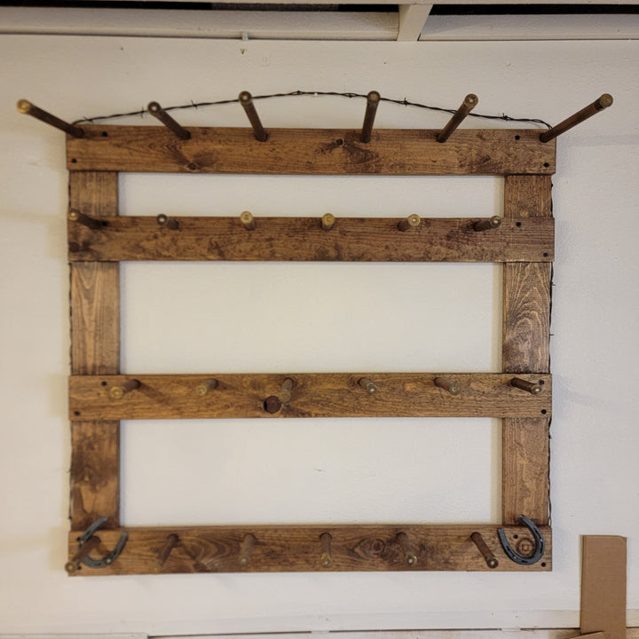 Wooden hat rack with multiple rows of metal hooks for hanging hats or caps