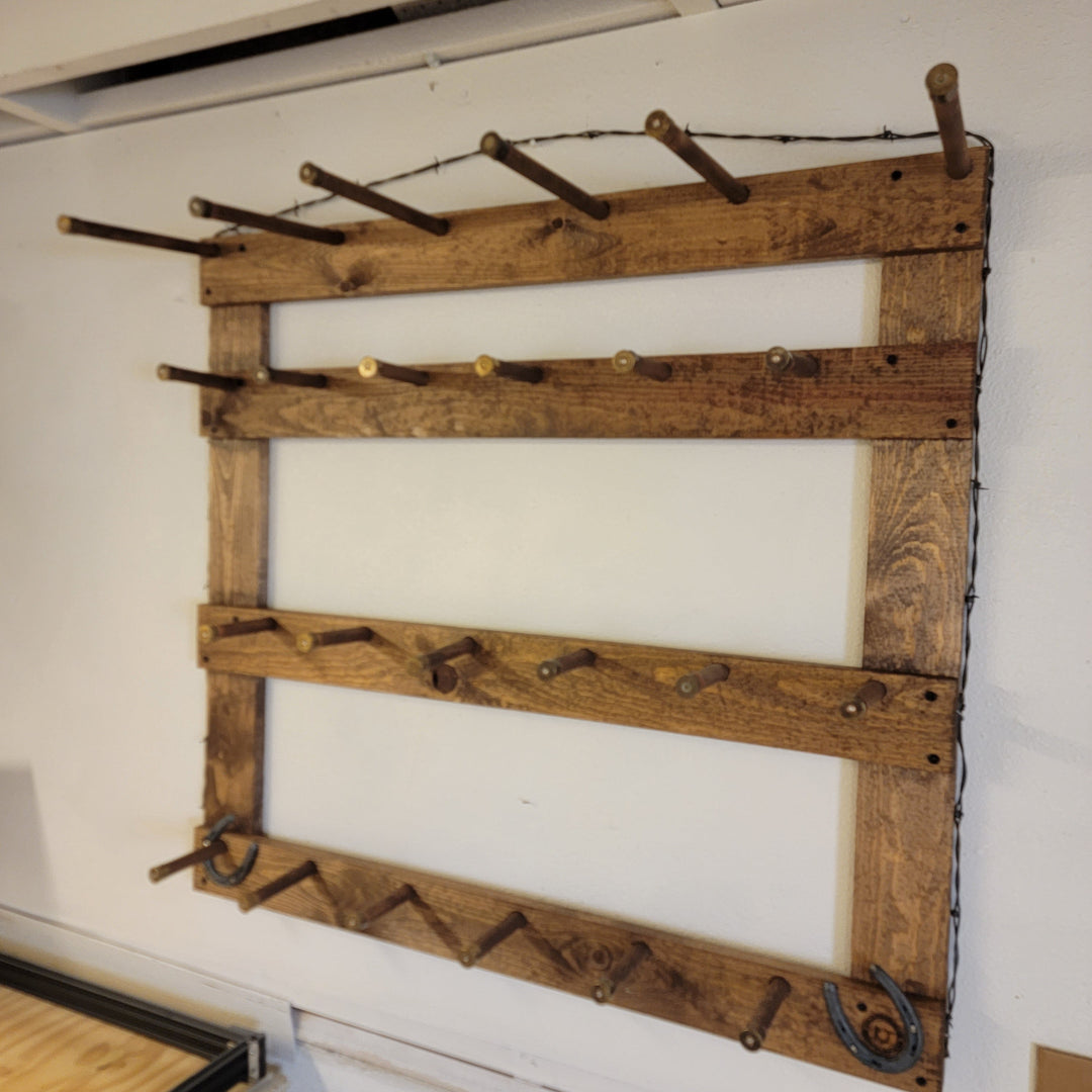 Wooden wall hat rack with horizontal bars and rows of metal hat hooks