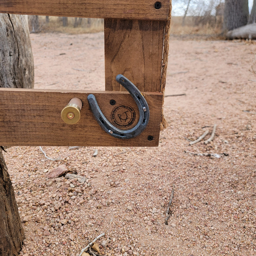 Wooden corner of a wall-hanging hat organizer with horseshoe hook and fasteners