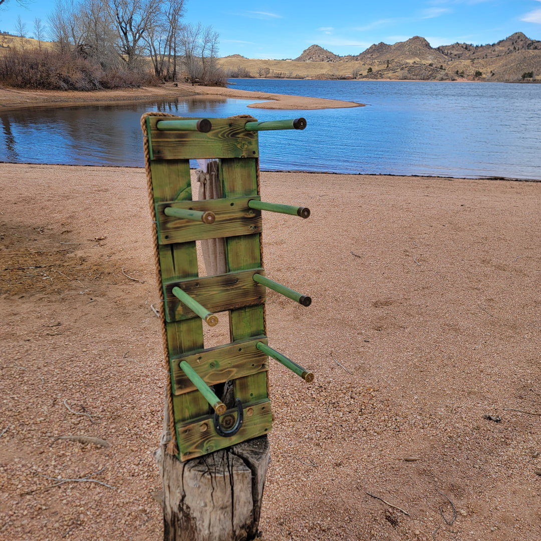 Green vertical western wall hanging organizer on a log base with mounted hooks