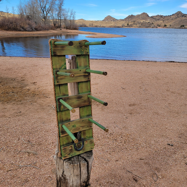 Green vertical western wall hanging organizer on a log base with mounted hooks