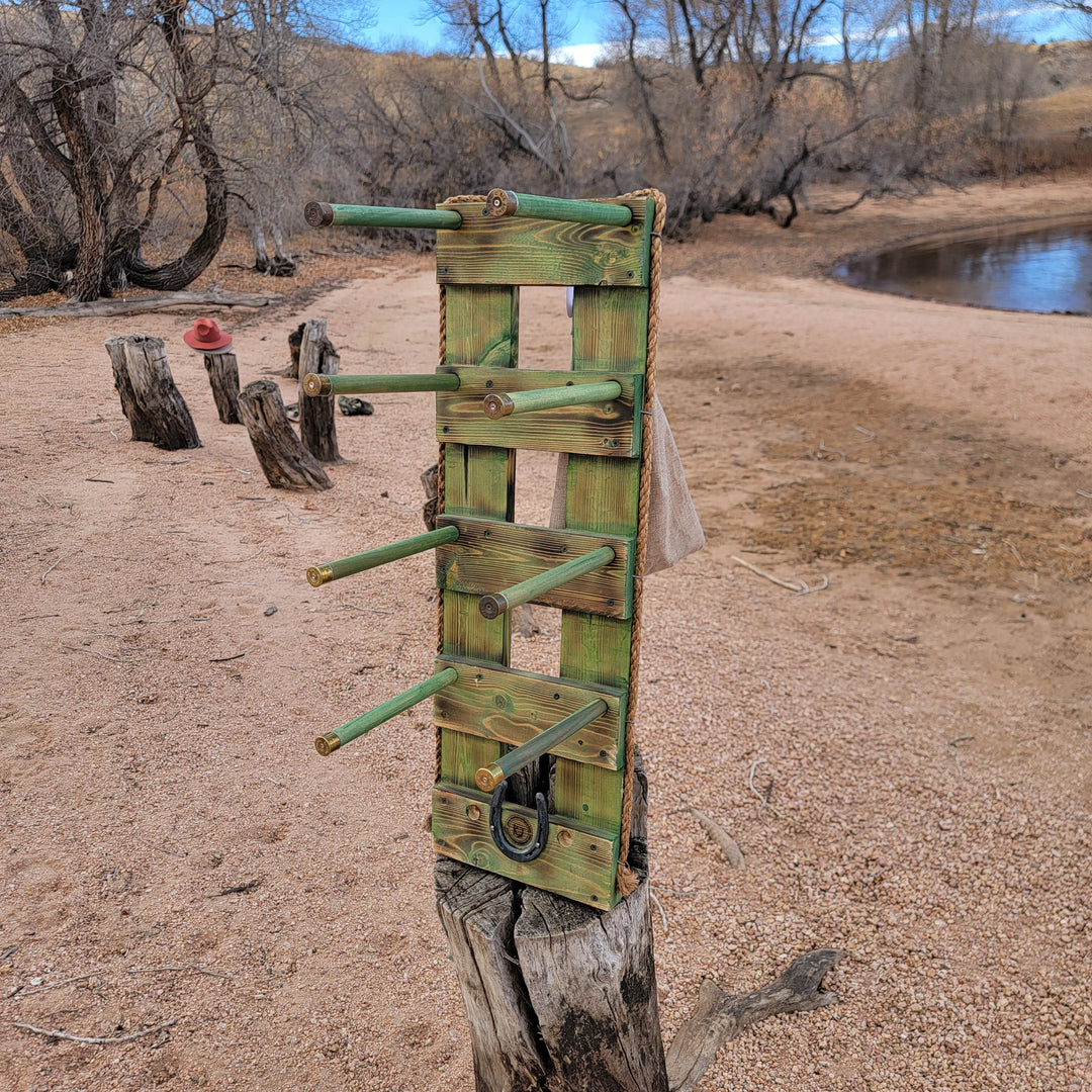Green wooden vertical wall hanging organizer with multiple hat brackets and hooks