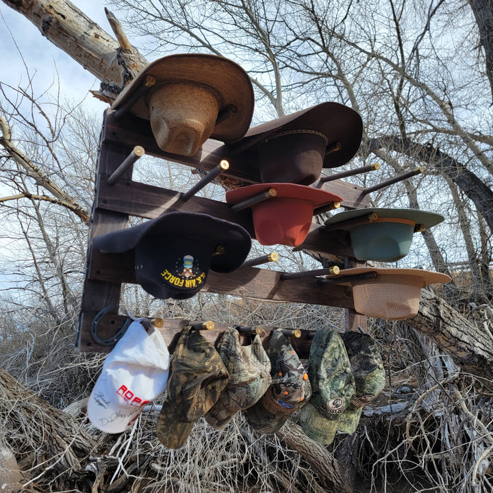 Wall-hanging hat organizer with multiple brimmed hats on horizontal wooden rails