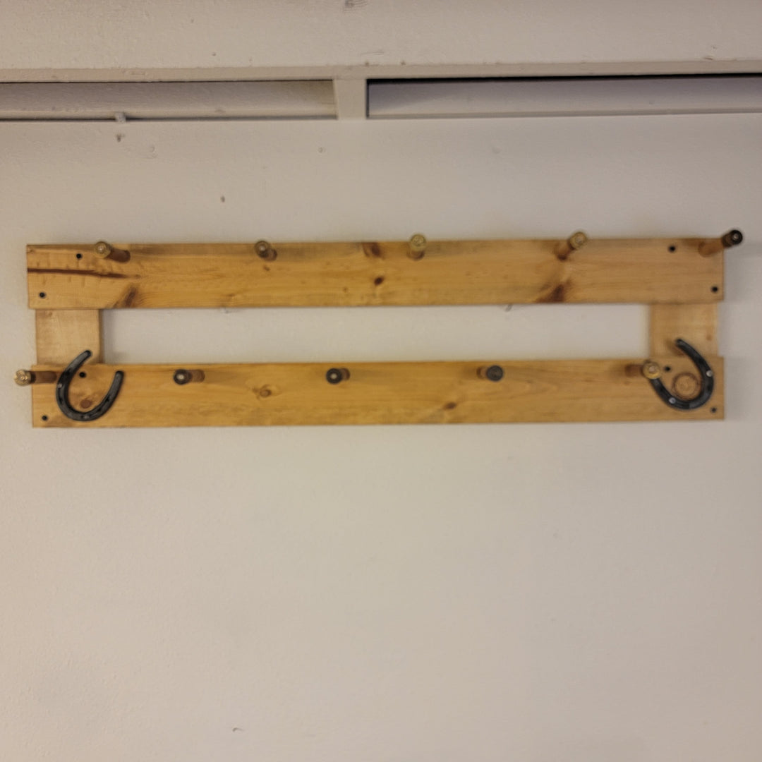 Wall-mounted coat rack base with two curved metal hooks on a wooden board