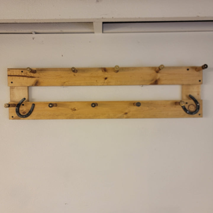 Wall-mounted coat rack base with two curved metal hooks on a wooden board