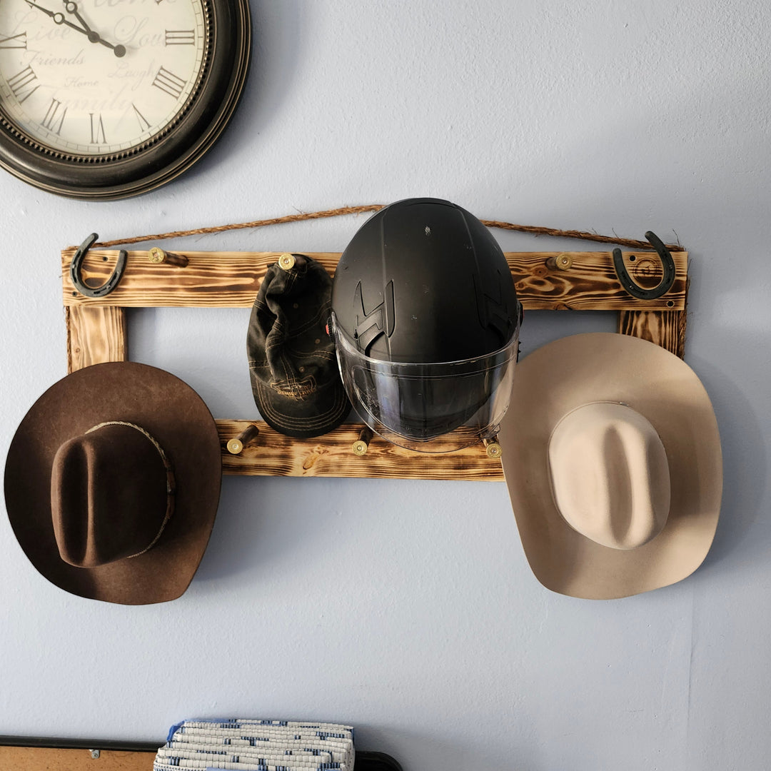 Wall-mounted heritage coat rack with hooks, featuring two hats and a jacket