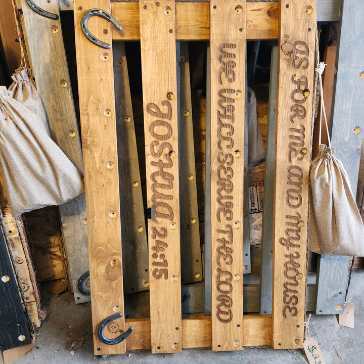 Vertical view of wooden wall organizer with stamped label panels and metal hooks