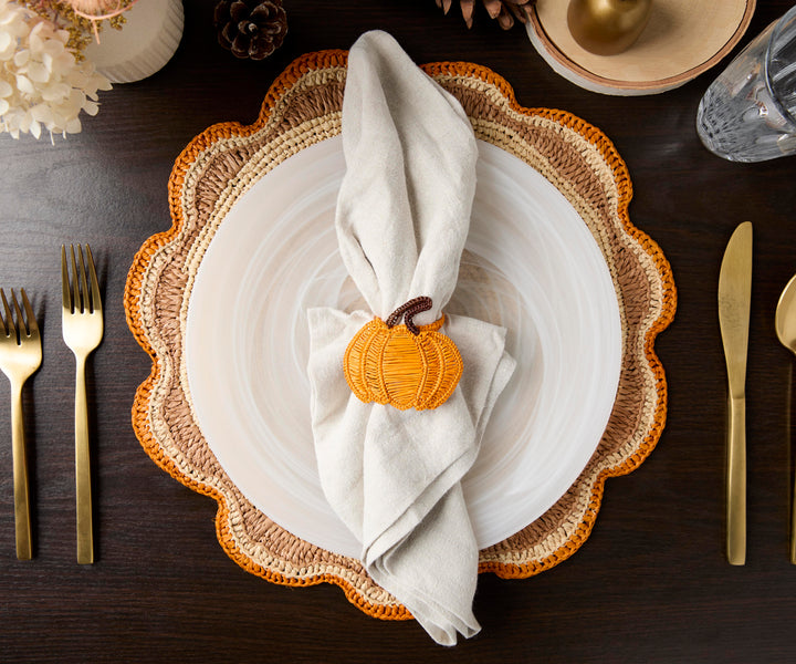 A handwoven Raffia Placemat in Tan, Orange & Brown