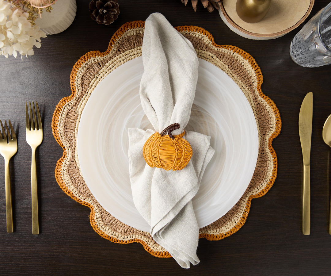 A handwoven Raffia Placemat in Tan, Orange & Brown