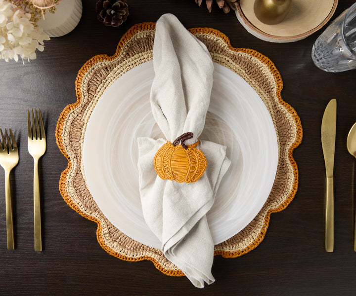 A handwoven Raffia Placemat in Tan, Orange & Brown