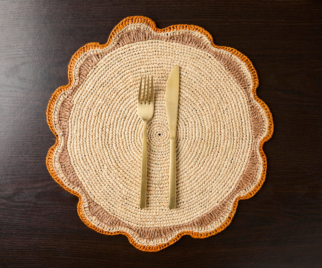 A handwoven Raffia Placemat in Tan, Orange & Brown