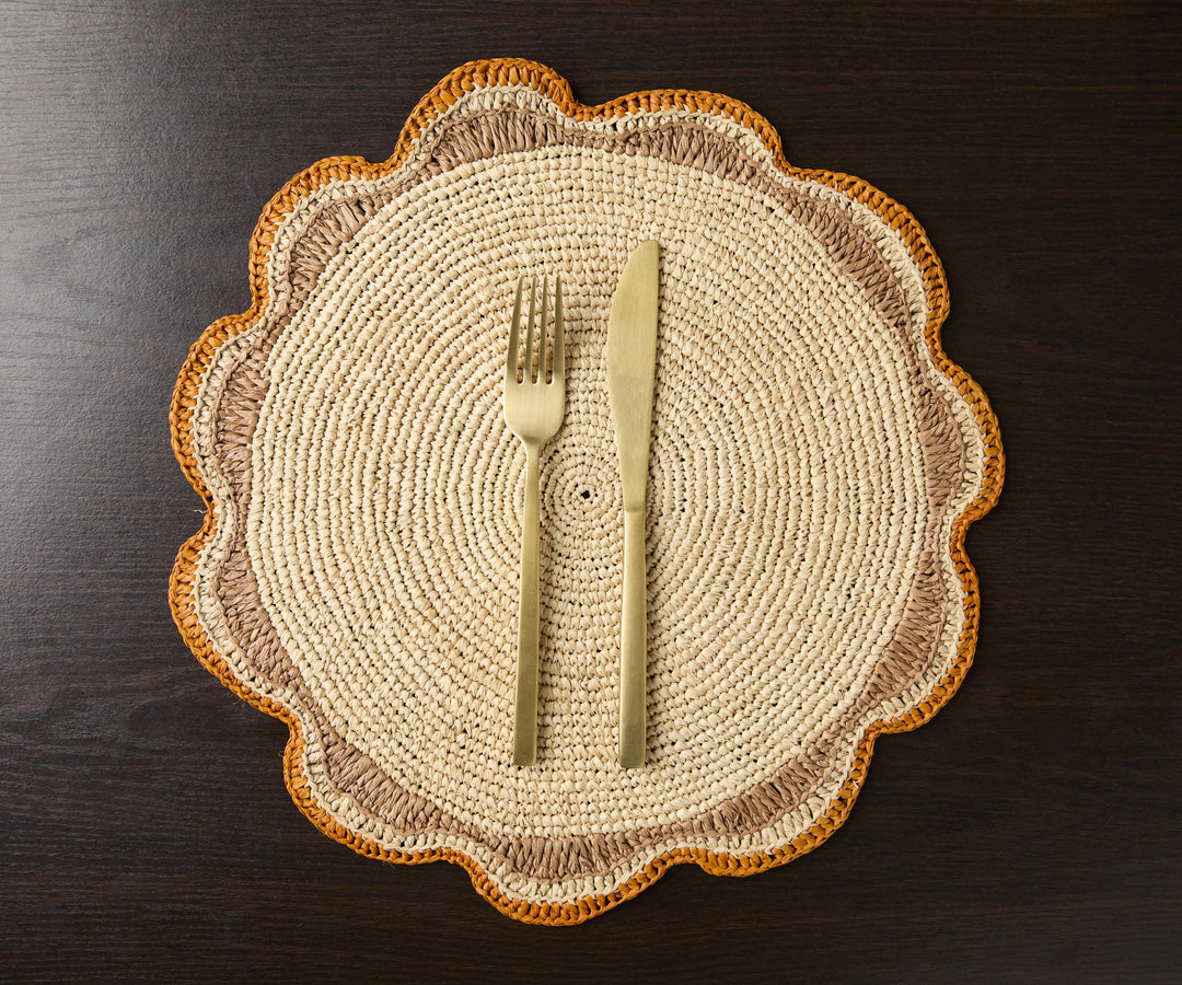 A handwoven Raffia Placemat in Tan, Orange & Brown