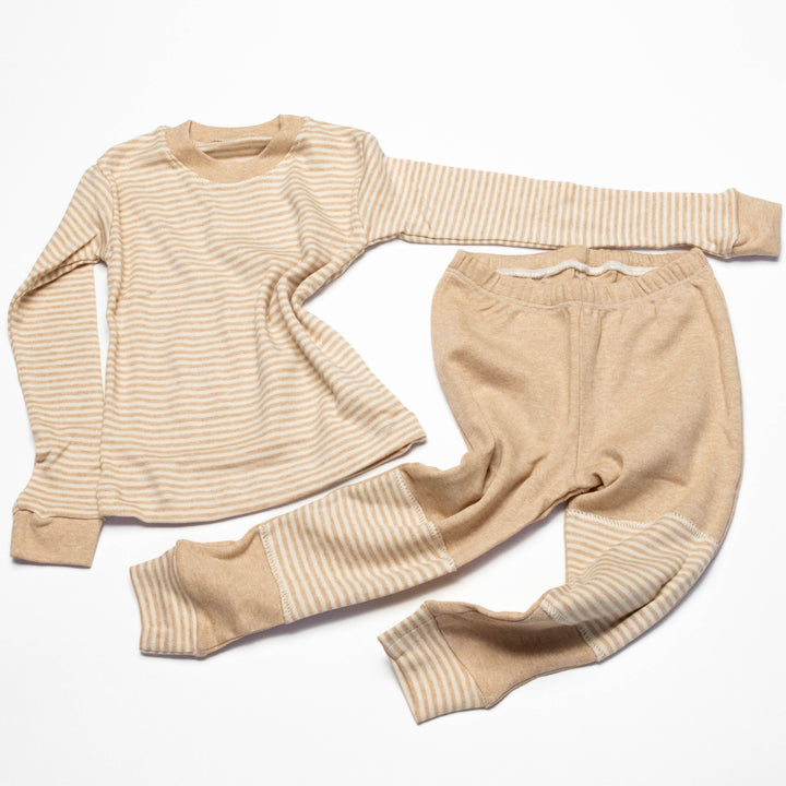 Baby pajama set laid flat: long-sleeve striped shirt with beige cuffs and matching striped joggers