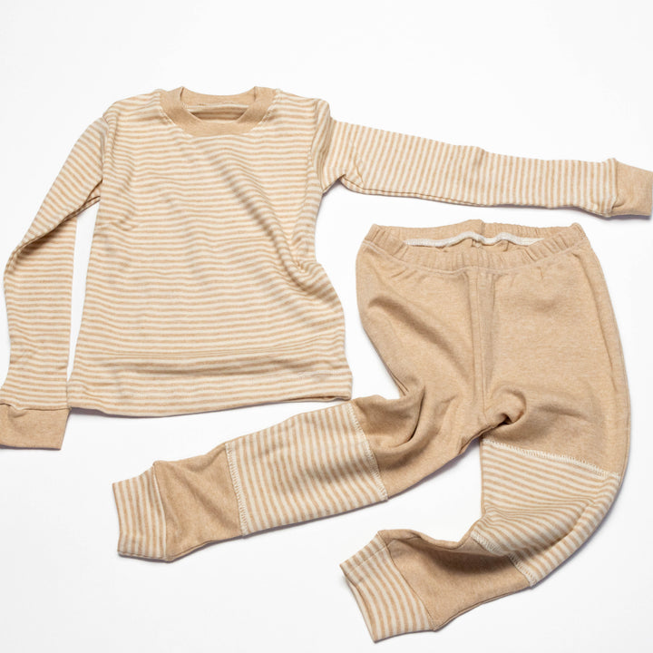 Baby pajama set overhead: long-sleeve striped shirt with matching striped pants and cuffs