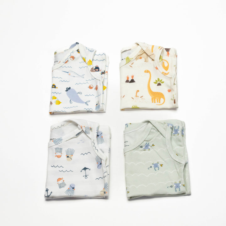 Toddler undershirt tops 4-pack, folded, featuring ocean and safari-style animal prints