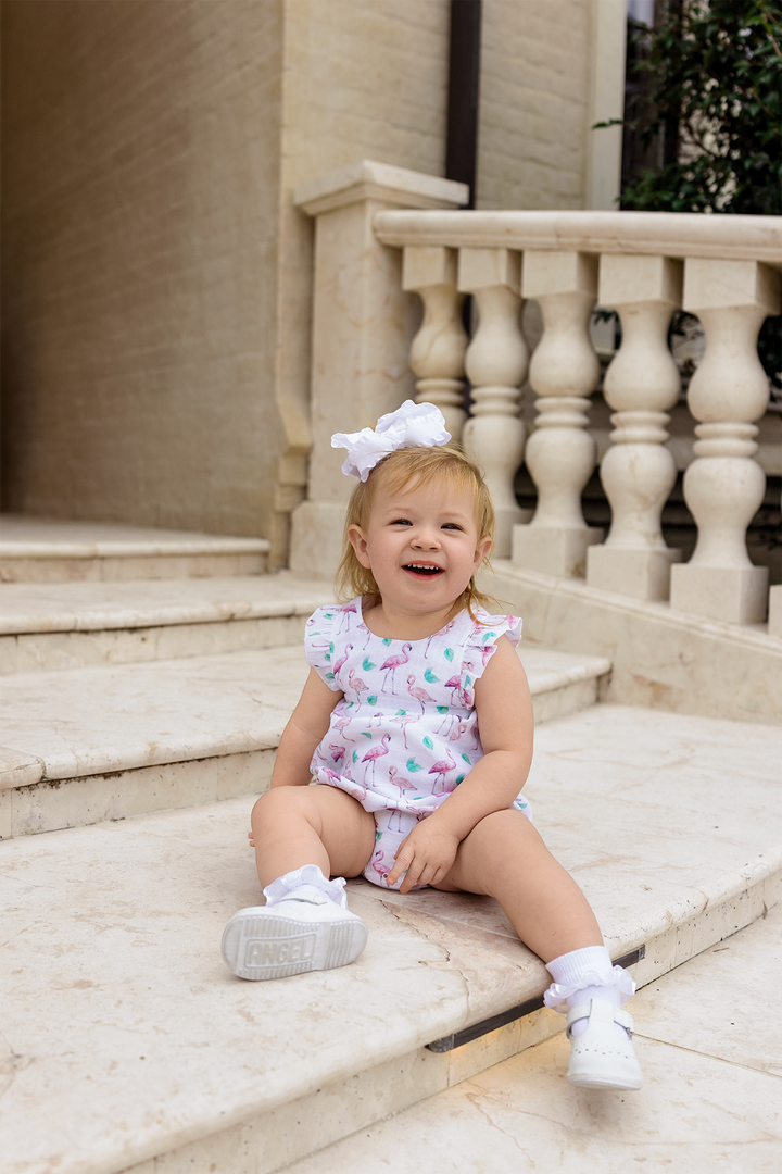 Flamingo-print muslin bubble romper with ruffled shoulders and diaper-style bottom