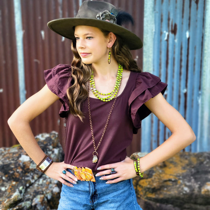 Olive felt cowgirl hat with distressed hand-painted finish and decorative hatband